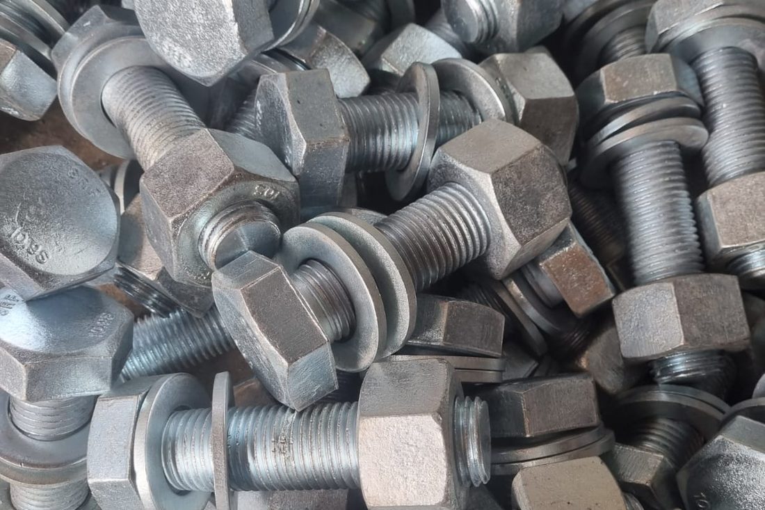 Heads of HSFG structural bolts stamped 10.9S and SRF, assembled with nuts and washers